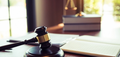 a judge's gavel, and documents and book on a table